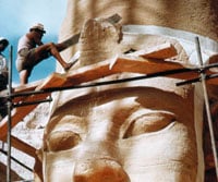 Person working on Egyptic sculpture.